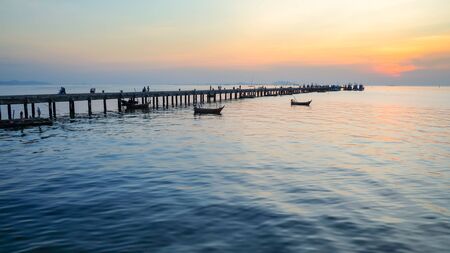 Sunset over the sea with jetty at Bangsaen Thailandの写真素材