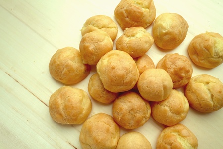 Profiteroles on wood background