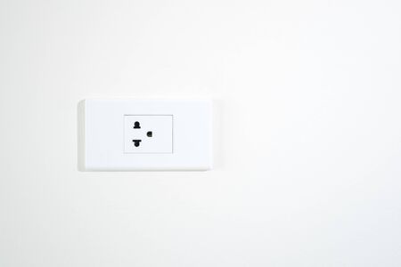 plug on white wall minimal textureの写真素材