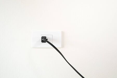 plug on white wall minimal textureの写真素材