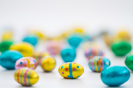 Lots of little, chocolate Easter eggs on an isolated white background.の写真素材