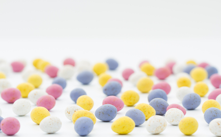 Lots of little, chocolate Easter eggs on an isolated white background.の写真素材