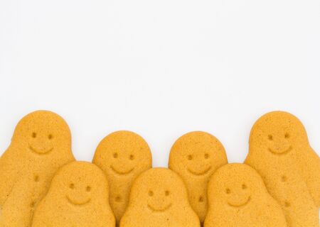 A row of happy gingerbread men on an isolated white background.の写真素材