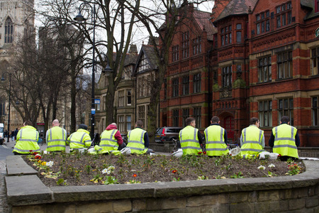YORK, UK - CIRCA MARCH, 2016. Construction workmen taking a break at lunchtime in their high visibility clothing and sitting outdoors on the streets of York, UK.のeditorial素材