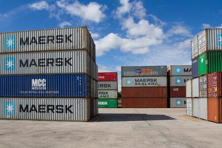 DONCASTER, YORKSHIRE, UK - JULY 30, 2016. Cargo and shipping containers stacked up at Doncaster Rail Port before being loaded onto freight trains to be exported from UK docks.のeditorial素材