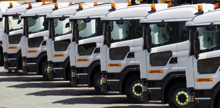 DONCASTER, YORKSHIRE, UK - JULY 30, 2016. A row of delivery trucks from the logistics company DHL parked up in their Doncaster depot waiting to be loaded for the movement of goods and freight around the UK.のeditorial素材