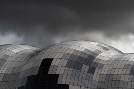 The Sage building in Gateshead, UK showing close up detail of the glass roof under a stormy skyの写真素材