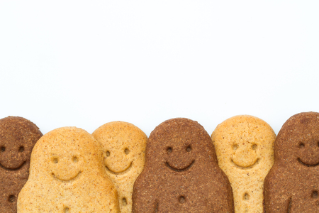 A row of black and white Gingerbread Men smiling and looking happy at the bottom of the frame...
