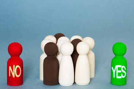 A voting concept with a group of voters and people deciding whether to vote yes or no to decide an election, referendum or ballotの写真素材