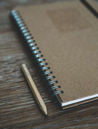 An old fashioned desk top with a ring binder note book and pencil for taking notes and creative writing with copy spaceの写真素材