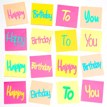 A square grid pattern with rows of pastel coloured sticky notes or adhesive notes with the song lyrics for Happy Birthday in an abstract, graphic background to celebrate a Birthdayの写真素材