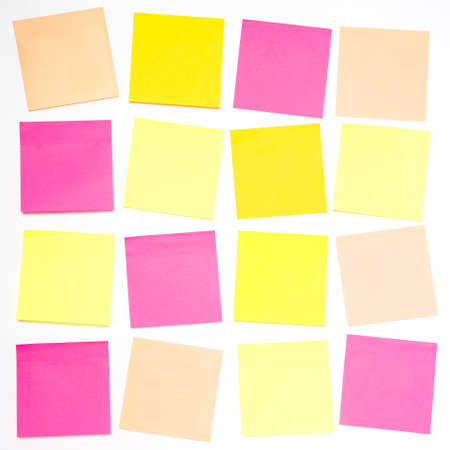 A square grid pattern with lots of blank, colourful sticky notes on a white background ready for personal messages with copy spaceの写真素材