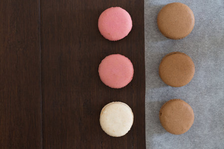 A flat lay from above of round colourful macaroonsの写真素材