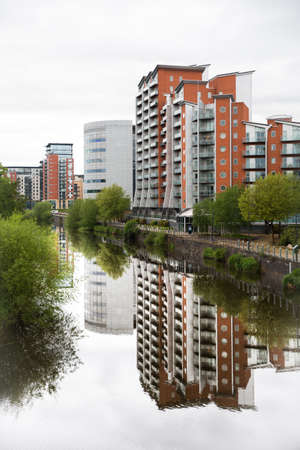 LEEDS, UK - MAY 25, 2021.  Waterfront apartment blocks with a riverside view in Leeds city centreのeditorial素材