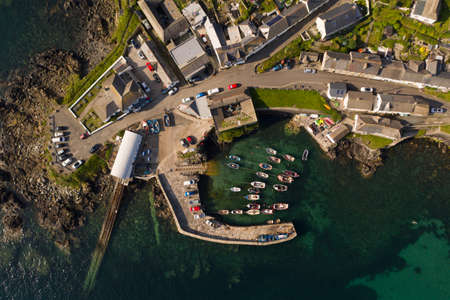 COVERACK, CORNWALL, UK - JUNE 30, 2021.  Aerial view of the picturesque harbour and village of Coverack in Cornwall, UKのeditorial素材