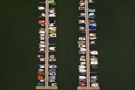 Aerial view of a the jetty of a sailing club in Helford, Cornwall full of small boatsの写真素材