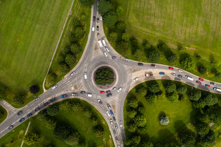 Aerial view of a busy countryside road roundabout at rush hour with traffic queueingの写真素材