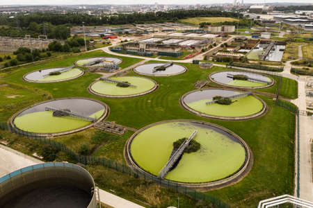 Aerial view of the tanks of a UK sewage and water treatment plant enabling the discharge and re-use of waste waterの写真素材