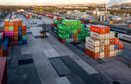 LEEDS, UK - NOVEMBER 22, 2021.  Aerial view of a busy shipping container rail terminal in Leeds with shipping boxes waiting to be loaded onto road and reail transportのeditorial素材