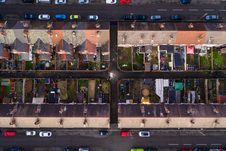 Aerial view of the rooftops of terraced houses and back gardens in a run down city in the North of Englandの写真素材