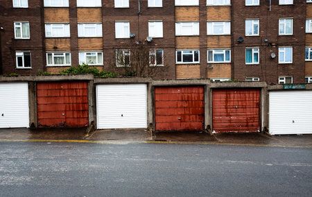 Front view of rows of back street garages on a UK council house estateの写真素材