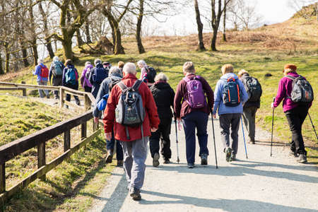 Lake District, UK - March 21, 2022.  A group of senior walkers taking an energetic walk in The lake District National Parkのeditorial素材