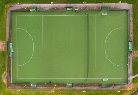 Aerial view directly above an amateur outdoor hockey club pitch with goals and line markingsの写真素材