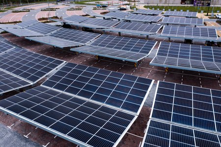 Aerial view above innovative solar panels located on a car parking lot rooftops making good use of small space in a cityの写真素材
