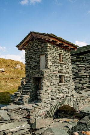 The exterior of a bridge and house made from slate at The Honister Slate Mine in The Lake District National Park is an example of Slate's versatility as a building materialの写真素材