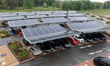 STOURTON, LEEDS, UK - MAY 16, 2022.  Aerial view above innovative solar panels located on a car parking lot rooftops making good use of small space in a cityのeditorial素材