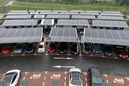 STOURTON, LEEDS, UK - MAY 16, 2022.  Aerial view above innovative solar panels located on a car parking lot rooftops making good use of small space in a cityのeditorial素材