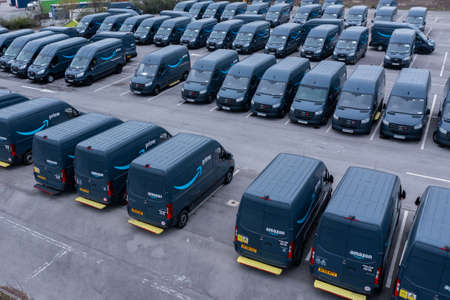 LEEDS, UK - APRIL 26, 2022.  An aerial view of a fleet of Amazon Prime delivery vans for delivering online shopping orders from fulfilment centres to homesのeditorial素材