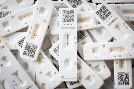 SELBY, UK - JUNE 6, 2022.  A positive result for Coronavirus on a lateral flow home testing kit with other results showing negative.のeditorial素材