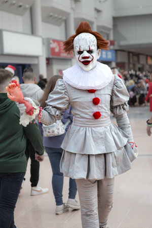 BIRMINGHAM NEC, UK - NOVEMBER 13, 2022.  A male cosplayer dressed as Pennywise The Clown from Stephen King's IT series of books and movies at MCM Birmingham Comic Con 2022のeditorial素材