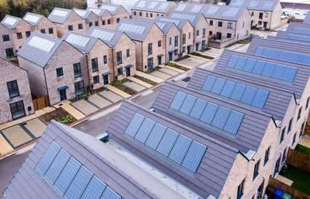 Aerial view of rows of new build energy efficient, modular terraced houses in the UK with characterless design for first time buyersの写真素材