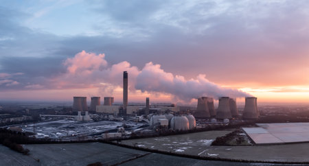 DRAX POWER STATION, UK - DECEMBER 17, 2022. Aerial landscape view of Drax Power Station in North Yorkshire with smoking chimneys and cooling towers pumping CO2 into the atmosphere at sunsetのeditorial素材