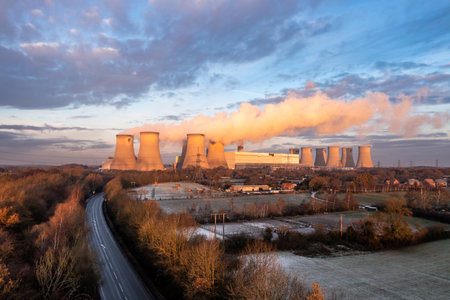 DRAX POWER STATION, UK - DECEMBER 17, 2022. Aerial landscape view of Drax Power Station in North Yorkshire with smoking chimneys and cooling towers with CO2 emissions at sunsetのeditorial素材