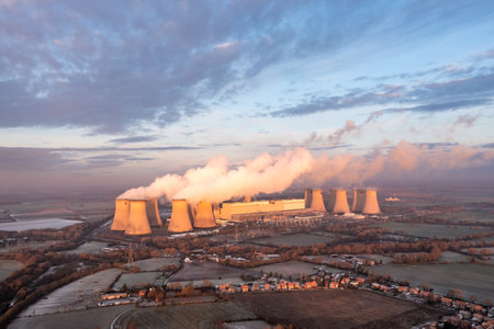DRAX POWER STATION, UK - DECEMBER 17, 2022. Aerial landscape view of Drax Power Station in North Yorkshire with smoking chimneys and cooling towers pumping CO2 into the atmosphere at sunsetのeditorial素材