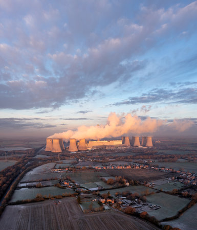DRAX POWER STATION, UK - DECEMBER 17, 2022. Aerial landscape view of Drax Power Station in North Yorkshire with smoking chimneys and cooling towers pumping CO2 into the atmosphere at sunsetのeditorial素材