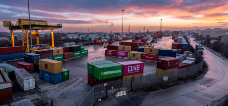 LEEDS, UK - JANUARY 19, 2023.  An aerial view of Freightliner Intermodal container terminal in Leeds at sunset with heavy machinery loading container boxes onto rail and road transportのeditorial素材