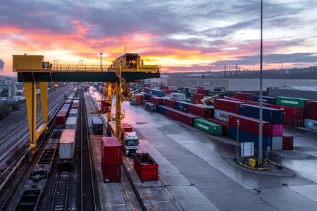 LEEDS, UK - JANUARY 19, 2023.  An aerial view of Freightliner Intermodal container terminal in Leeds at sunset with heavy machinery loading boxes onto rail and road transportのeditorial素材