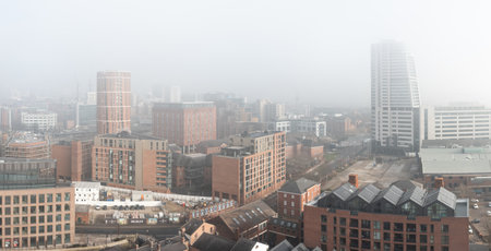 LEEDS, UK - FEBRUARY 14, 2023.  An aerial panoramic view of Leeds cityscape skyline with The Bridgewater Place skyscraper clouded in fog and mist reducing visibilityのeditorial素材