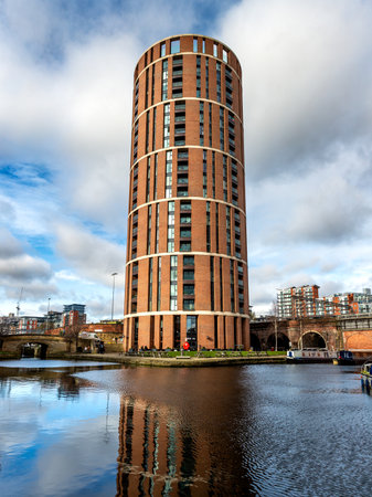 GRANARY WHARF, LEEDS, UK - FEBRUARY 16, 2023.  Architecture image of waterfront apartments in Candle House tower block with a view of the Leeds to Liverpool canal at Granary Wharf in Leeds city centreのeditorial素材