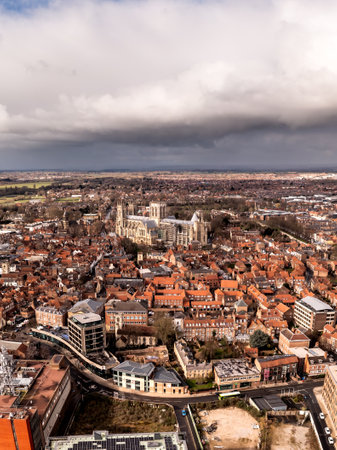 A vertical aerial landscape view of York cityscape skyline in North Yorkshire, UK with York Minster cathedral and the rooftop of historic buildingsの写真素材