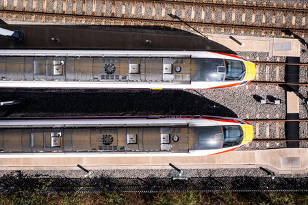 DONCASTER, UK - MAY 13, 2023. Aerial view directly above Hitachi Azuma LNER high speed passenger trains in a maintenance yard with overhead electric wiresのeditorial素材
