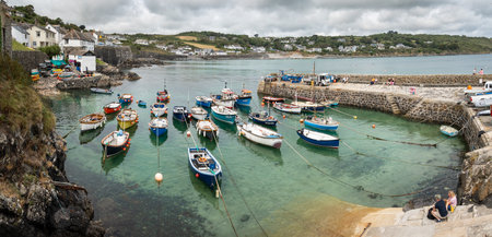 COVERACK, CORNWALL, UK - JUNE 27, 2023.   Landscape view of traditional Cornish fishing boats moored...