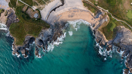 Aerial landscape panorama view of Church Cove with it's historic church and at Gunwalloe in Cornwall with collapsed cliffs showing coastal erosionの写真素材