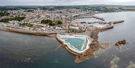 Aerial panorama landscape of the Cornish coast town of Penzance from the ocean with harbour and Jubilee swimming pool and copy spaceの写真素材