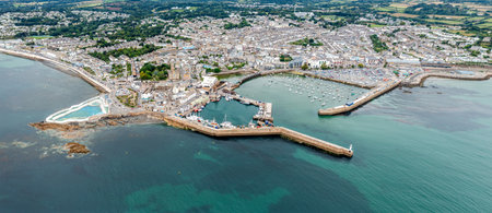Aerial panorama landscape of the Cornish coast town of Penzance from the ocean with harbour and Jubilee swimming pool and copy spaceの写真素材