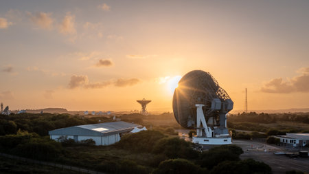 GOONHILLY SATELLITE EARTH STATION, CORNWALL, UK - JULY 2, 2023.  Aerial view of a satellite dish pointing upwards to the sky at sunset sending and receiving communications from deep spaceのeditorial素材